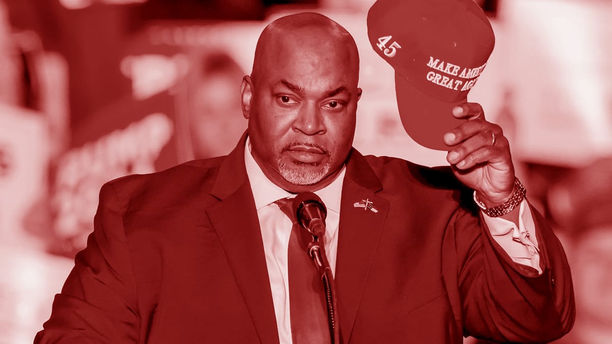 Colorized image of North Carolina Lt. Gov. Mark Robinson holding a MAGA hat